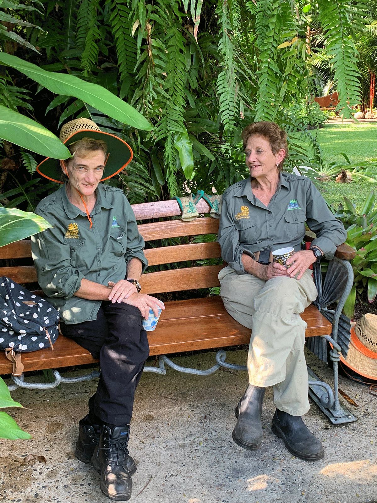 Volunteers take a break on one of the wrought iron feature benches in the Botanic Gardens
