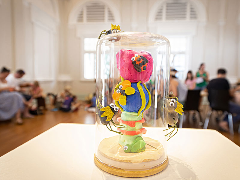 plasticine insects displayed in an upside down glass jat