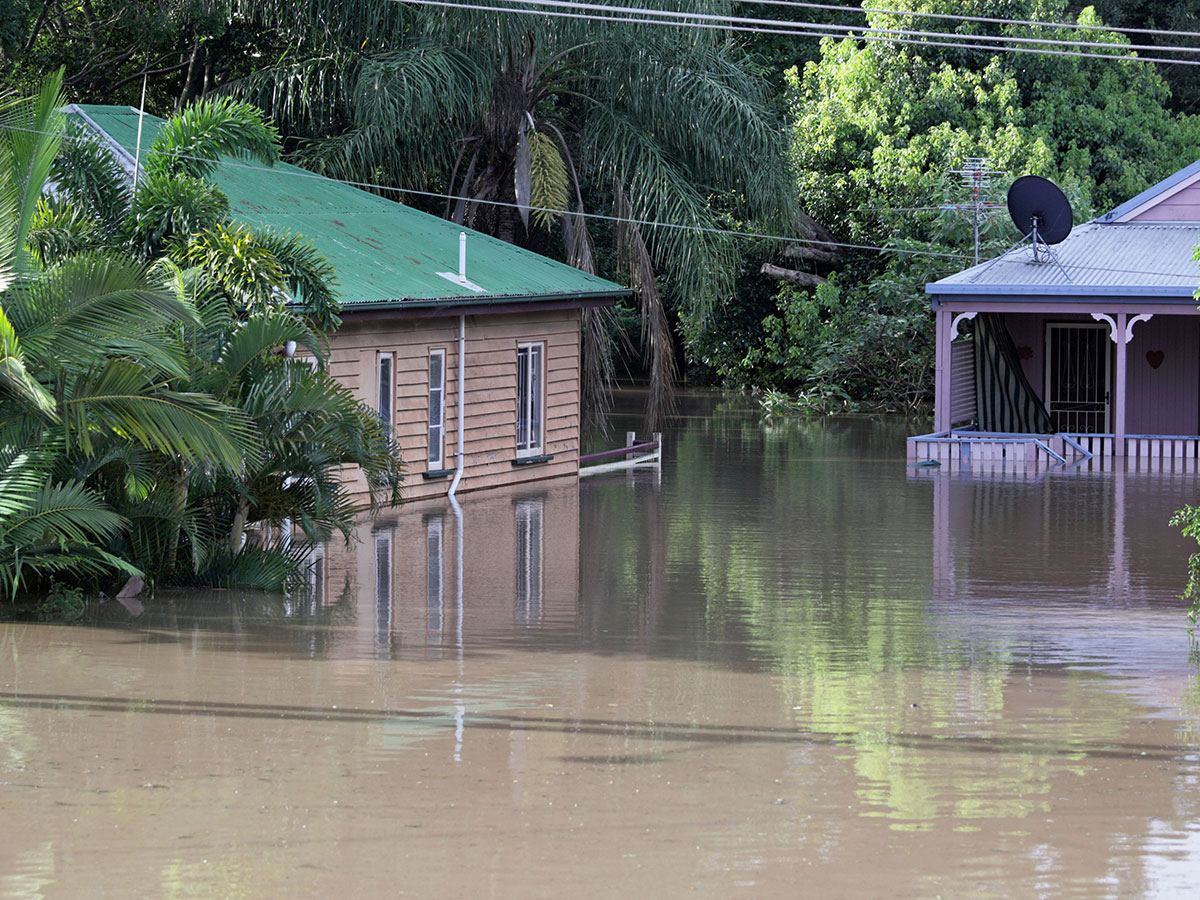 Two Queenslanders surrounded by flood waters