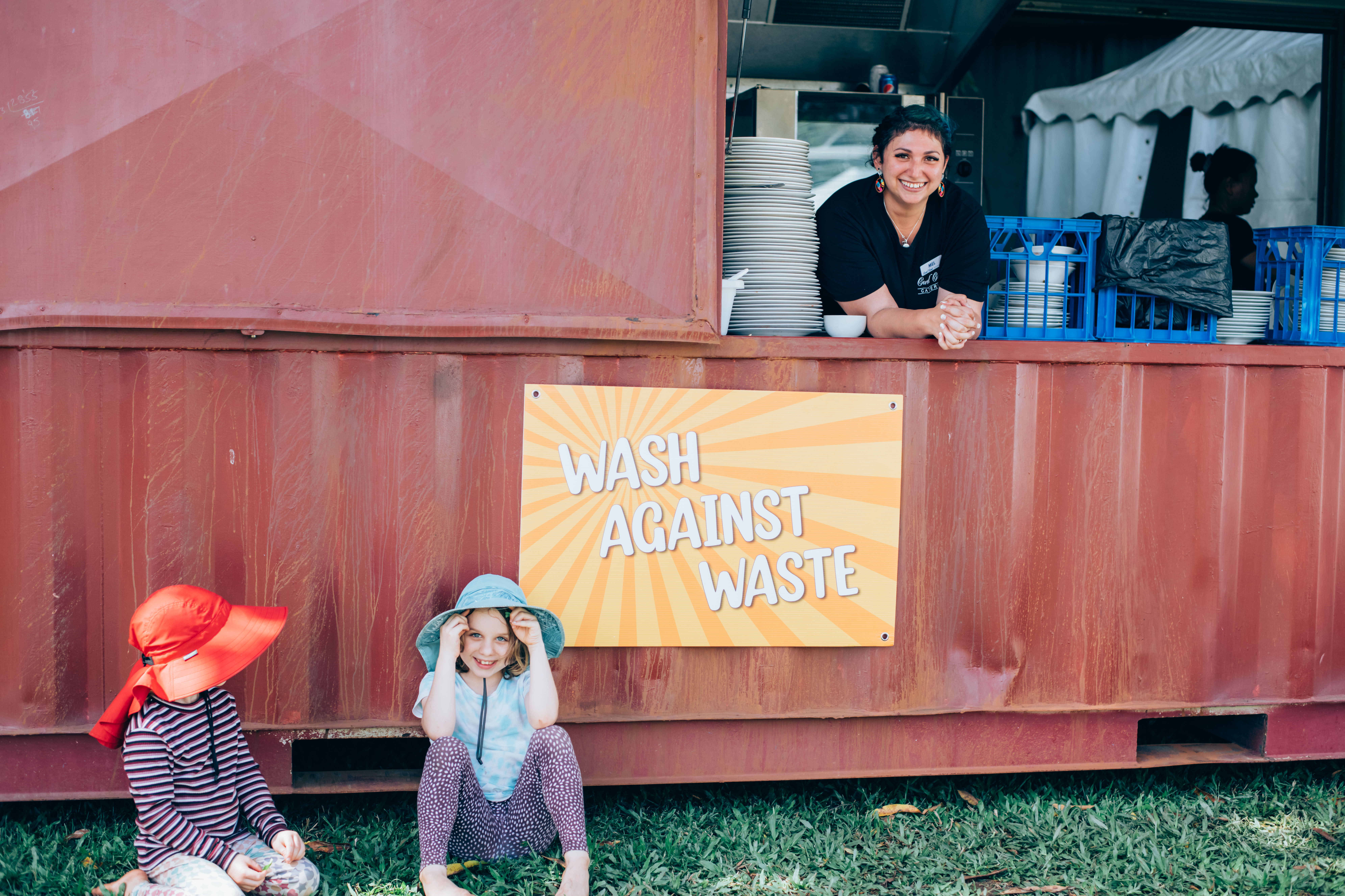 Smiling lady, with two children at Ecofiesta Wash Against Waste