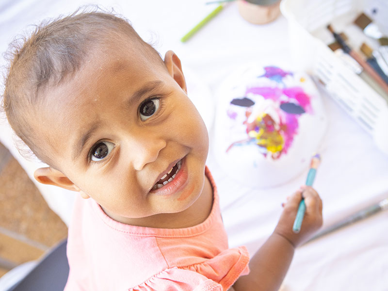 Adorable big-eyed baby painting at Cairns Children's festival