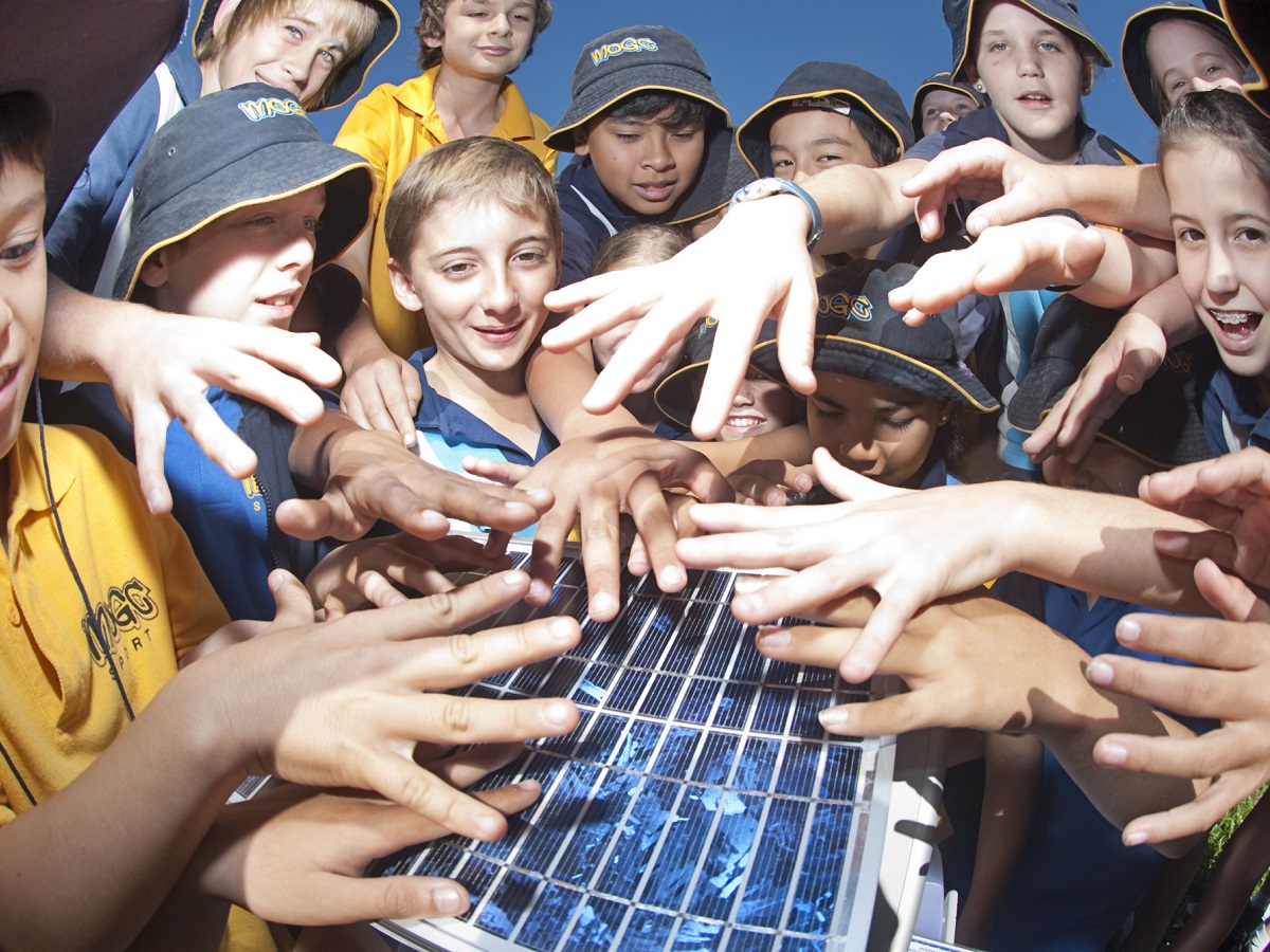 Children playing with a solar panel.