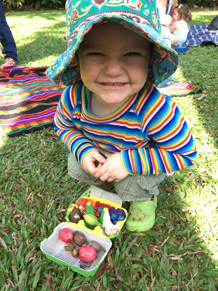 Smiling young child with painted egg carton